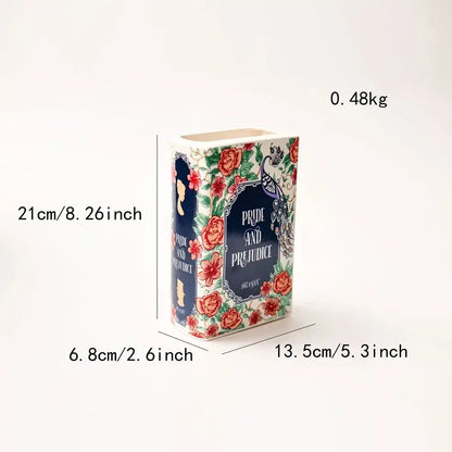 Navy ceramic book vase with colorful floral border and book-style navy label Pride and Prejudice on Tampa Home & Garden Store
