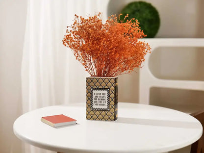 Navy ceramic book vase with gold geometric pattern and orange dried flowers on a table on Tampa Home & Garden Store