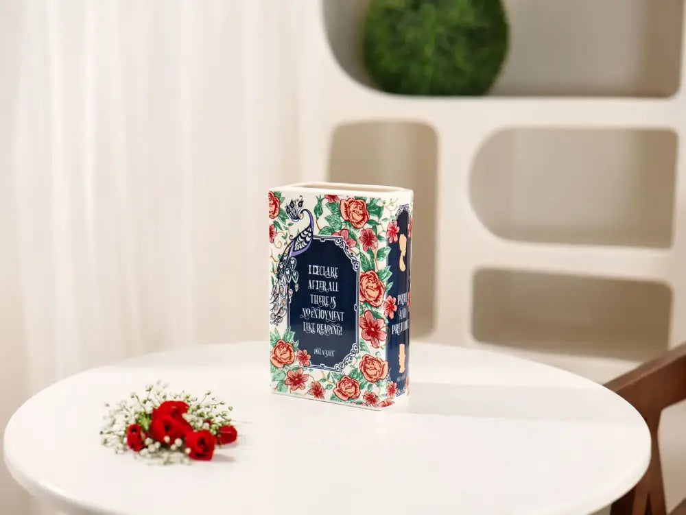 Navy ceramic book vase by Decorbites with floral border design on white table on Tampa Home & Garden Store