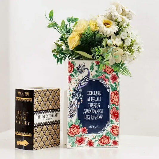 Navy ceramic book vase by Decorbites, bookish vase with floral border and white bouquet on Tampa Home & Garden Store