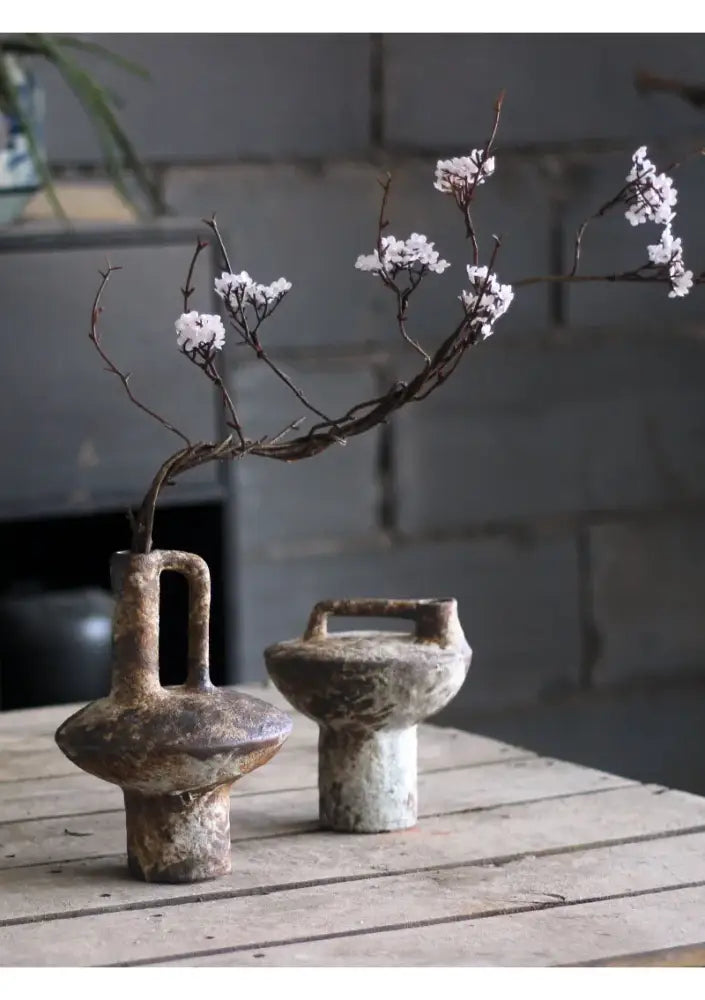 Gray ceramic vase set Decorbites; pair of vases holding a branch with white blossoms on a wooden table on Tampa Home & Garden Store