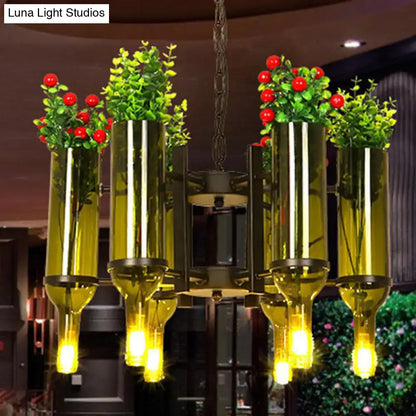 Green glass bottle chandelier by Decorbites with four tall vases, yellow bulbs, and red berries on Tampa Home & Garden Store