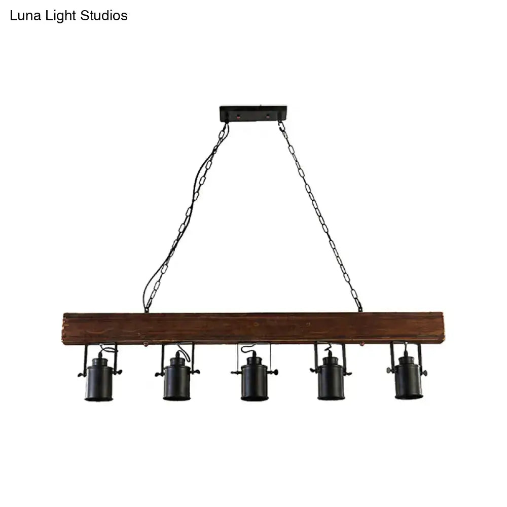 Black metal kitchen pendant light with five jar-shaped fixtures suspended from a rustic dark wood beam on Tampa Home & Garden Store