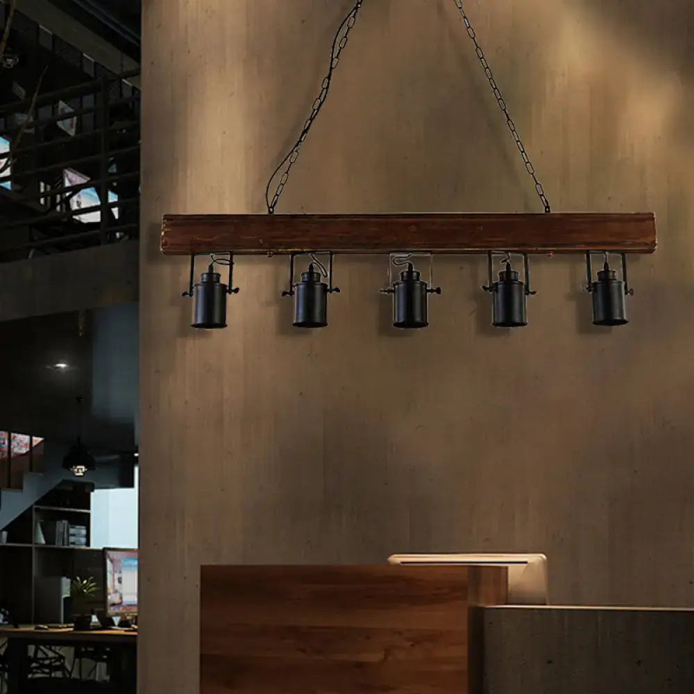 Black metal kitchen pendant lights by Decorbites, five hanging fixtures from a wood beam on Tampa Home & Garden Store