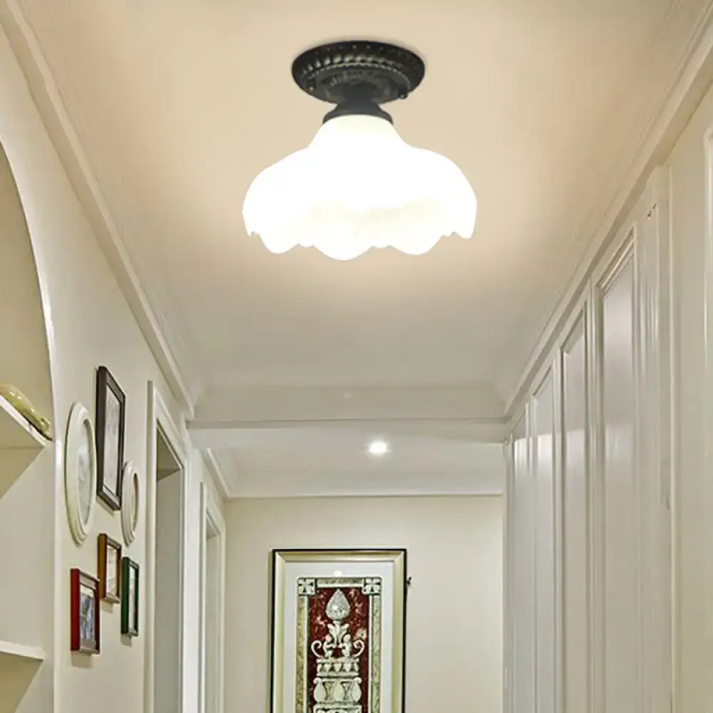 White glass ceiling light flush mount with scalloped shade and black canopy in hallway on Tampa Home & Garden Store