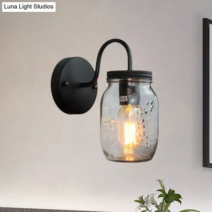 Black jar glass wall lamp by Decorbites with curved black arm and bubbled mason jar shade on Tampa Home & Garden Store