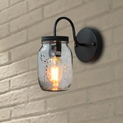 Black jar glass wall lamp with curved arm mason-jar shade and Edison bulb on black backplate on Tampa Home & Garden Store