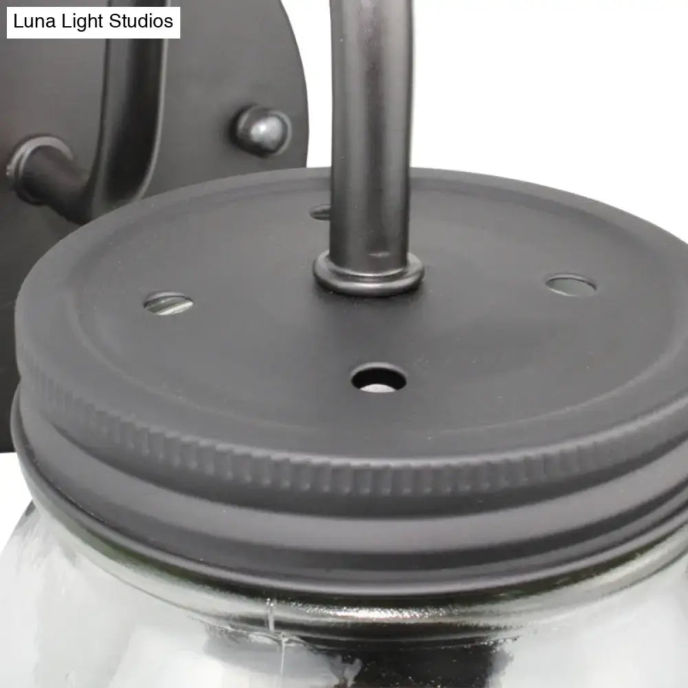 Black jar glass wall lamp close-up with black lid featuring holes and central mounting rod on Tampa Home & Garden Store