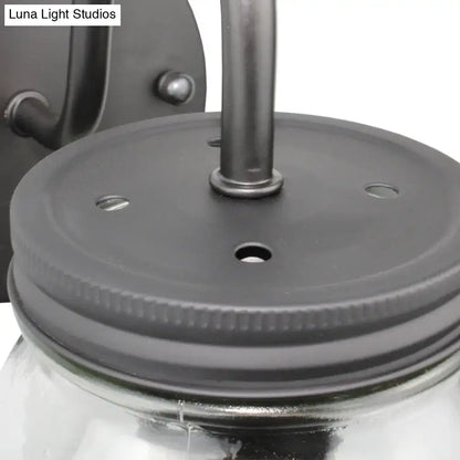 Black jar glass wall lamp close-up with black lid featuring holes and central mounting rod on Tampa Home & Garden Store