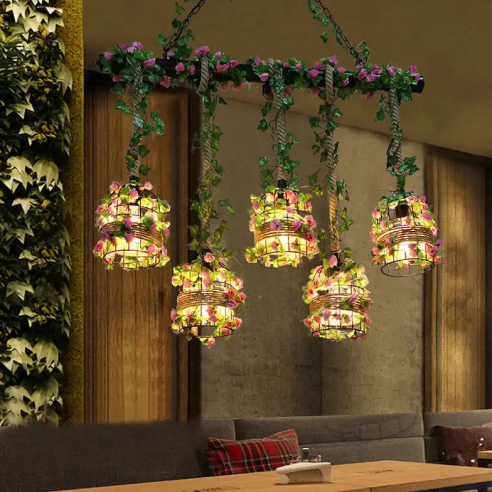 Industrial black metal cage pendant lights with pink flowers, five hanging lamps on Tampa Home & Garden Store
