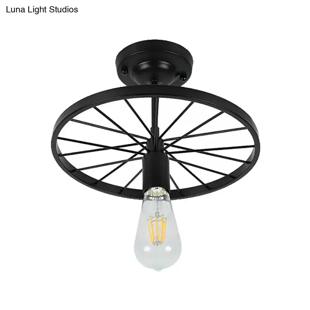Black wheel flush mount ceiling light with exposed Edison bulb, metal spokes on Tampa Home & Garden Store