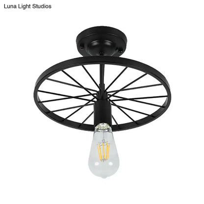 Black wheel flush mount ceiling light with exposed Edison bulb, metal spokes on Tampa Home & Garden Store