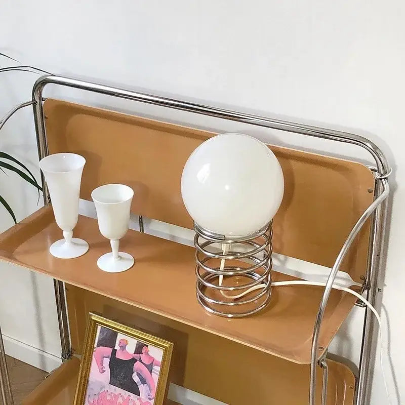 Chrome Glass USB Lamp by Decorbites, white glass globe on a chrome spiral base atop a metal shelf on Tampa Home & Garden Store
