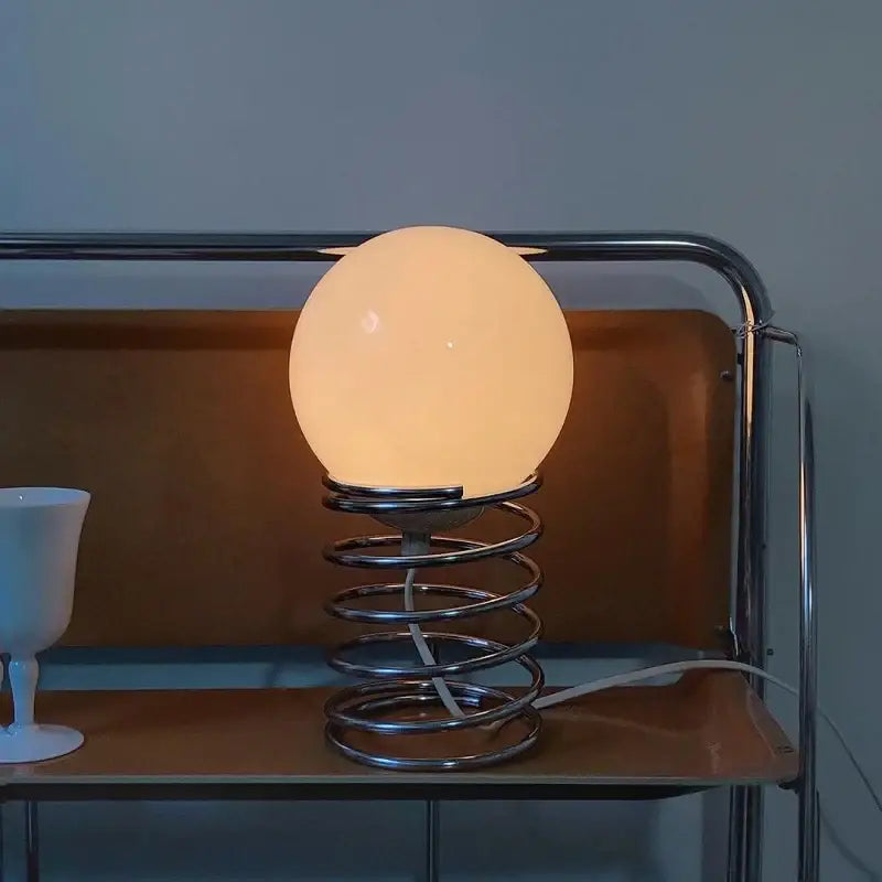 Chrome glass USB lamp Decorbites with frosted globe on spiral metal base beside white cup on Tampa Home & Garden Store