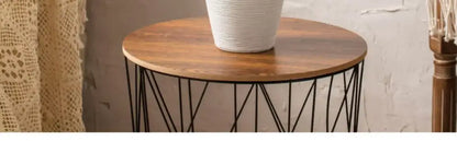 White ribbed ceramic vase by Decorbites on wooden round table with black metal base on Tampa Home & Garden Store