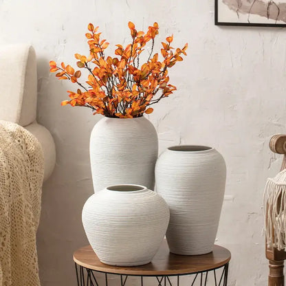 White ribbed ceramic vase set of three in varied heights on a round wooden table Decorbites on Tampa Home & Garden Store