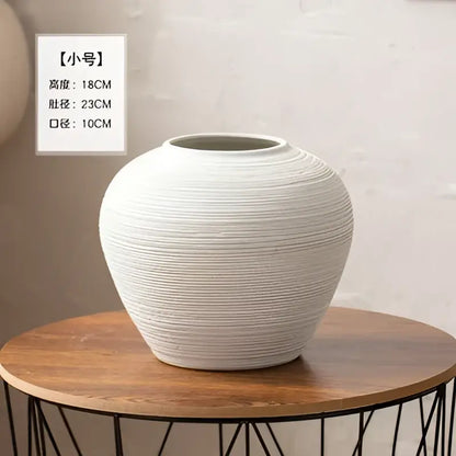 White ribbed ceramic vase by Decorbites, bulbous with grooves, wide mouth on wood table on Tampa Home & Garden Store