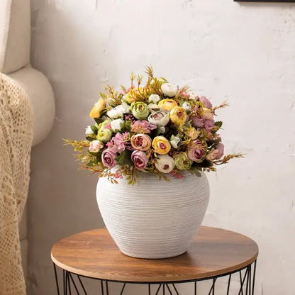 White ribbed ceramic vase by Decorbites with pastel bouquet on round wooden table on Tampa Home & Garden Store