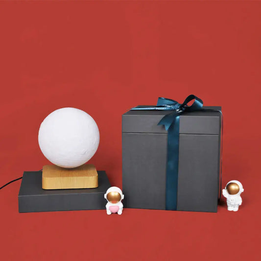 Moon sphere LED night light white on wood base by Decorbites beside gift box with ribbon on Tampa Home & Garden Store