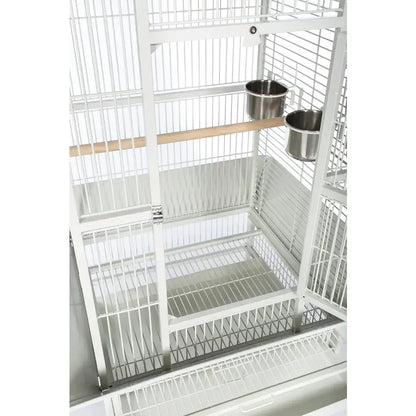 Chalk white metal birdcage with wooden perch and two side-mounted stainless steel bowls on Tampa Home & Garden Store