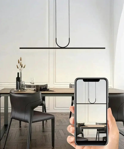 Chandelier Decorbites Nordic black metal LED pendant with a curved loop over dining table on Tampa Home & Garden Store
