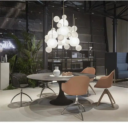 Chandelier Decorbites modern Nordic bubble ball LED pendant over round dining table with tan chairs on Tampa Home & Garden Store