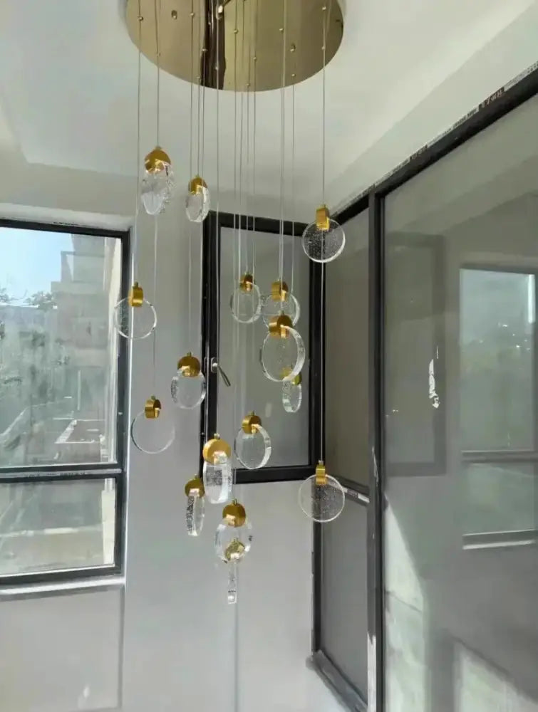 Modern gold LED crystal pendant light for bedroom with 12 hanging orbs and gold caps from canopy on Tampa Home & Garden Store