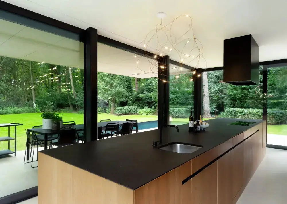 Chandelier modern LED firefly kitchen pendant light with looping metal arms over a black island on Tampa Home & Garden Store