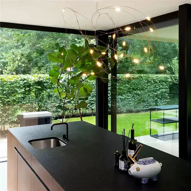 Chandelier Decorbites modern LED firefly pendant with metal wires over black kitchen island on Tampa Home & Garden Store