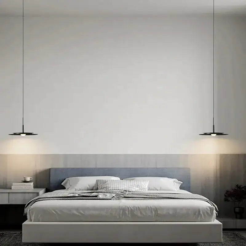 Minimalist black flying saucer pendant lights Decorbites, two disk pendants over a modern bed on Tampa Home & Garden Store