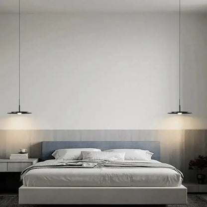 Minimalist black flying saucer pendant lights Decorbites, two disk pendants over a modern bed on Tampa Home & Garden Store