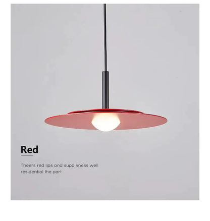 Red flying saucer pendant light with a black cord for dining room illumination on Tampa Home & Garden Store