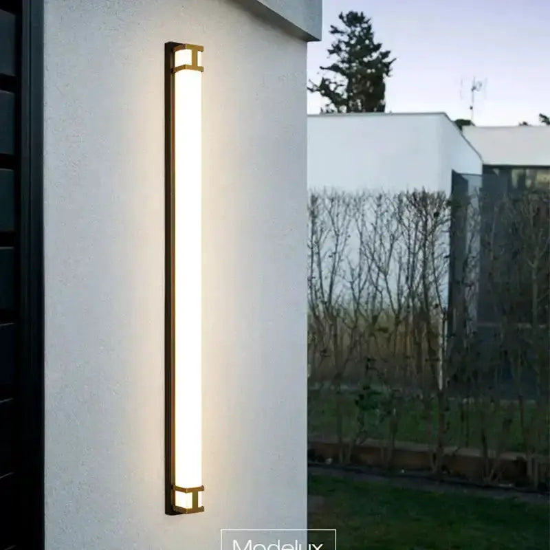 Modern black and gold LED outdoor wall lamp garden sconce by Decorbites on white exterior wall on Tampa Home & Garden Store