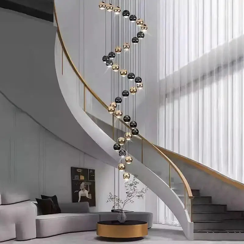 Modern black & gold globe pendant chandelier with multiple heads spiraling along a staircase on Tampa Home & Garden Store