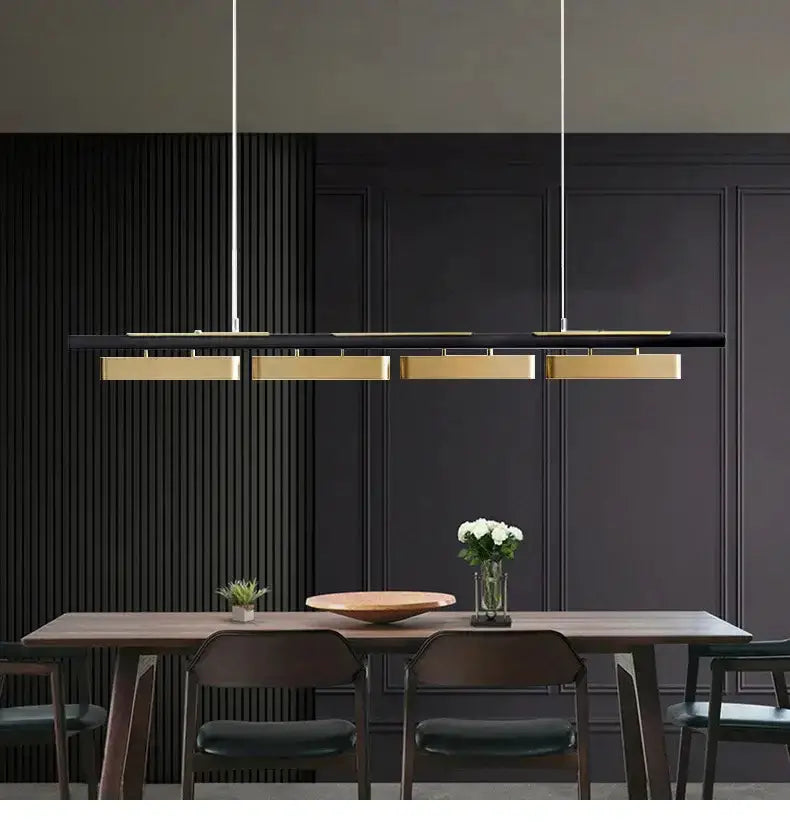 Modern minimalist strip LED black and gold pendant chandelier by Decorbites over a dining table on Tampa Home & Garden Store