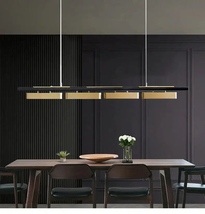 Modern minimalist strip LED black and gold pendant chandelier by Decorbites over a dining table on Tampa Home & Garden Store