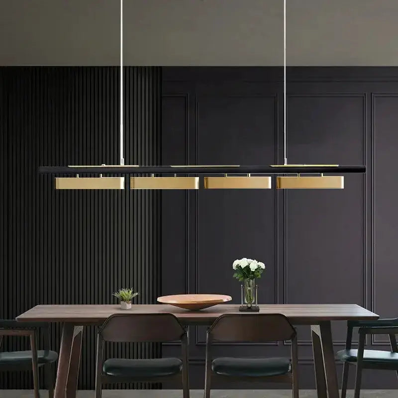 Chandelier by Decorbites: black and gold strip LED pendant lights over dark wood dining table on Tampa Home & Garden Store