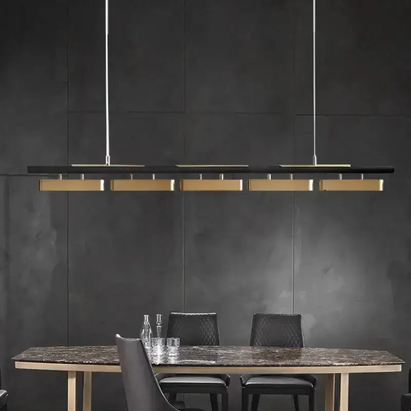 Chandelier: Decorbites black and gold strip LED pendant lights over marble dining table on Tampa Home & Garden Store
