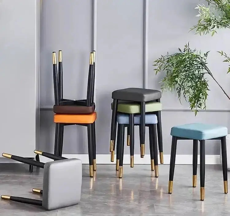 Decorbites low square dining stools set with orange and gray seats; black legs with brass tips on Tampa Home & Garden Store