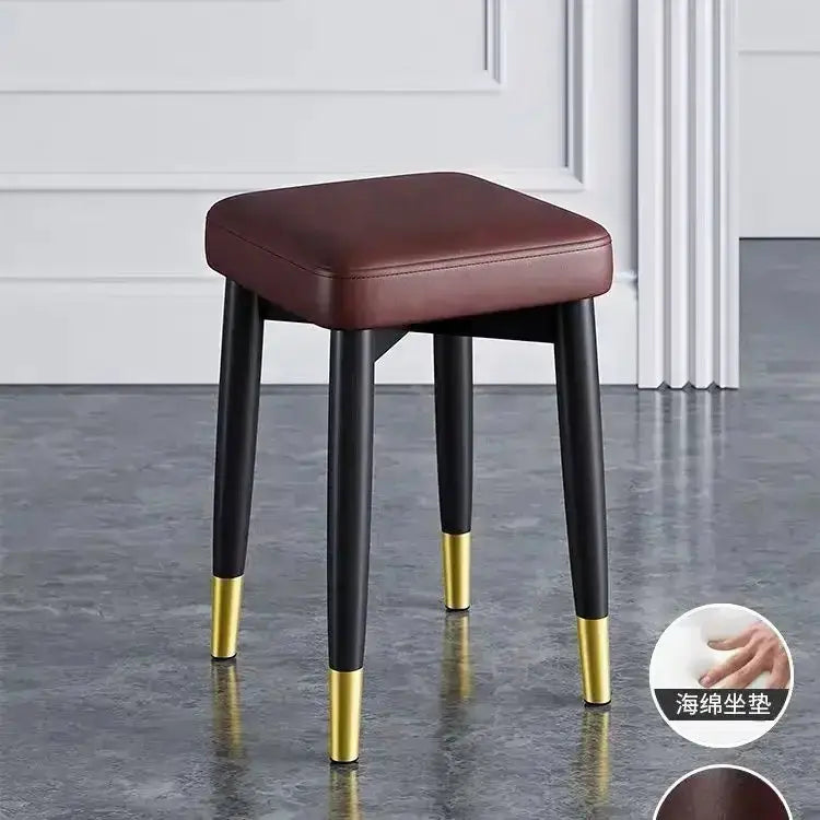 Decorbites modern low dining stool with brown upholstered seat and black legs with gold tips on Tampa Home & Garden Store