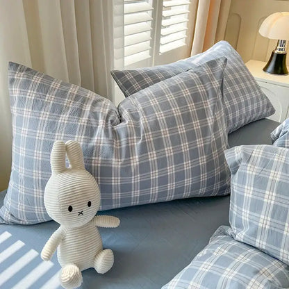 Blue plaid Duvet Set by Decorbites with pillow shams on bed beside plush bunny on Tampa Home & Garden Store