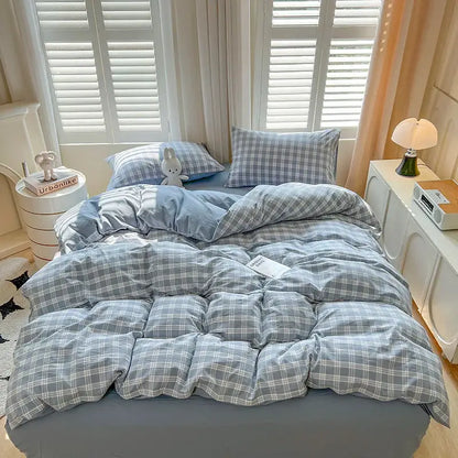 Blue plaid duvet set by Decorbites on bed with two matching plaid pillows on Tampa Home & Garden Store