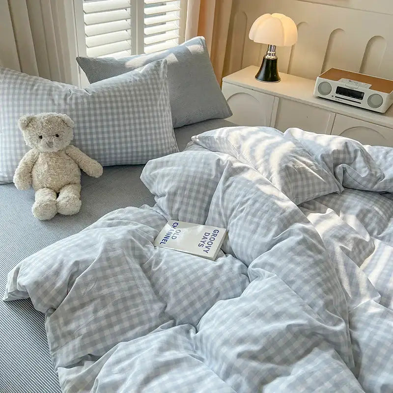 Blue plaid duvet set by Decorbites on bed with matching pillows and light blue gingham bedding on Tampa Home & Garden Store
