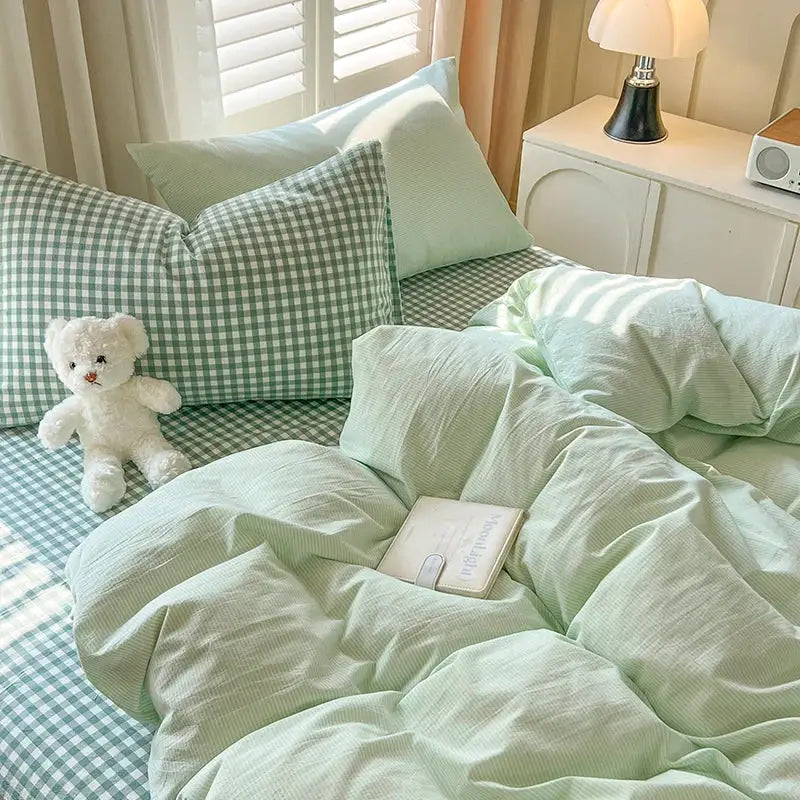 Blue Plaid Duvet Set by Decorbites with mint solid duvet cover and gingham pillow shams on bed on Tampa Home & Garden Store