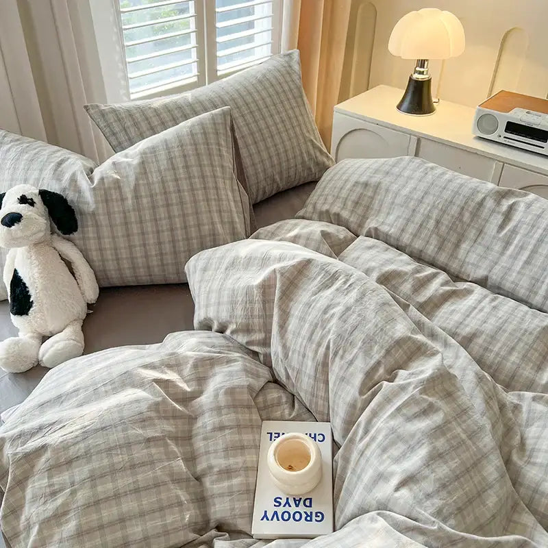 Blue plaid duvet set by Decorbites with matching plaid pillow shams on a rumpled bed on Tampa Home & Garden Store