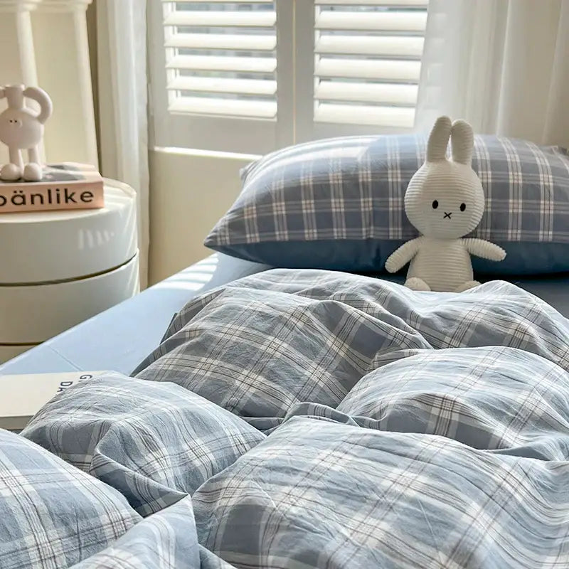 Blue plaid duvet set by Decorbites on a bed with matching pillowcase and a plush bunny on Tampa Home & Garden Store