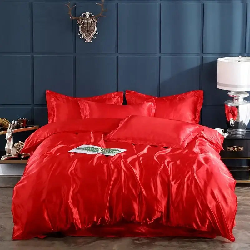 Duvet set by Decorbites in red satin on bed with matching pillows, dark blue wall backdrop on Tampa Home & Garden Store
