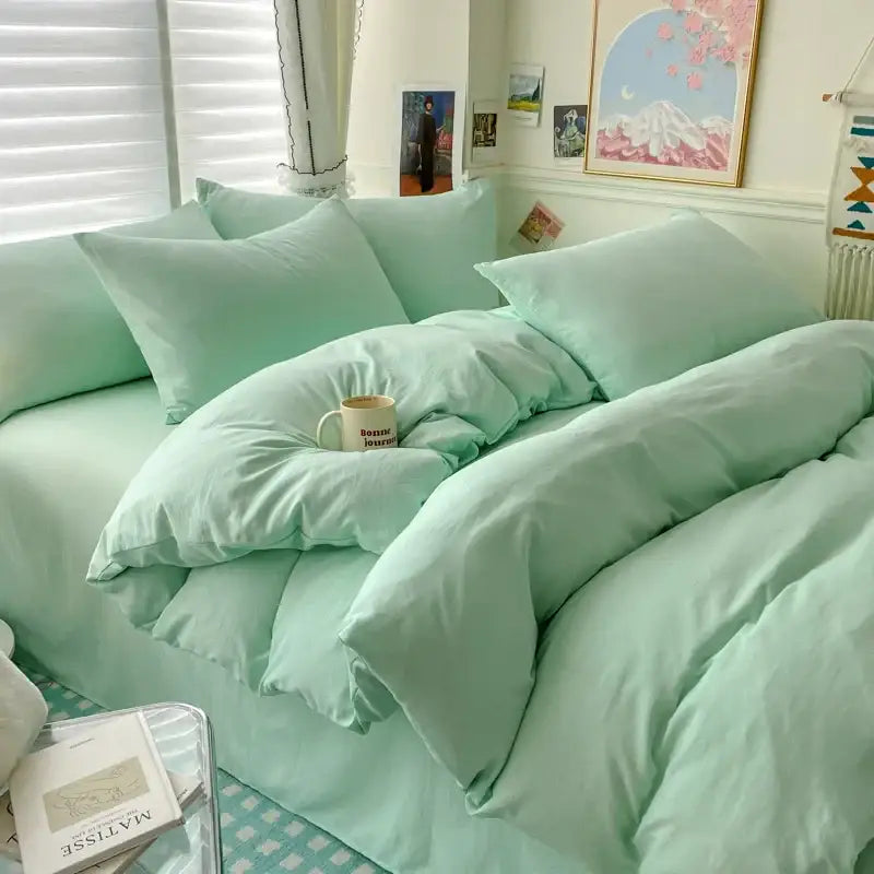 Decorbites cotton duvet cover set in mint green with matching pillows on a cozy bedroom bed on Tampa Home & Garden Store
