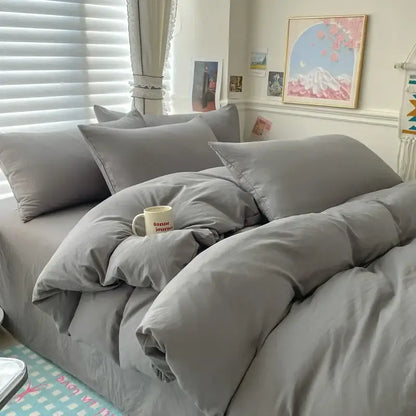 Duvet cover set in white and dark gray cotton by Decorbites on bed with pillows on Tampa Home & Garden Store