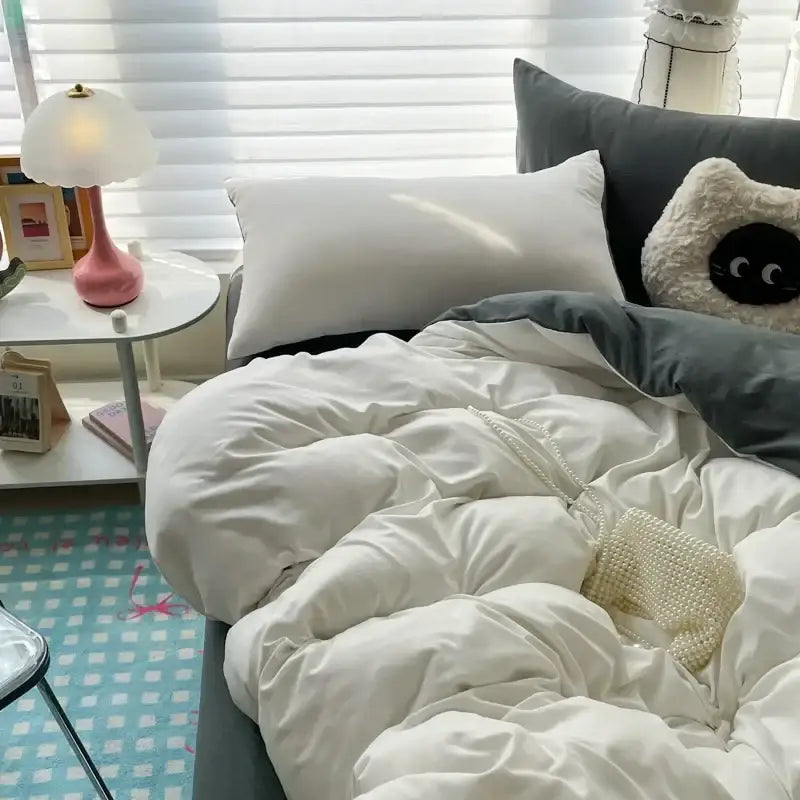 Decorbites white and dark gray duvet cover set on bed with white-gray pillows on Tampa Home & Garden Store
